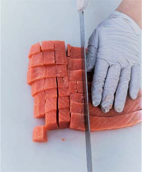 Hand cutting salmon